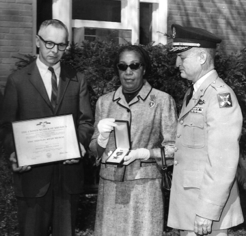 Robert A. Davis' mother with the Bronze Star Medal